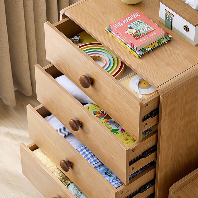 Round wooden drawer knobs on children's dresser, smooth natural wood furniture handles for nursery storage cabinets
